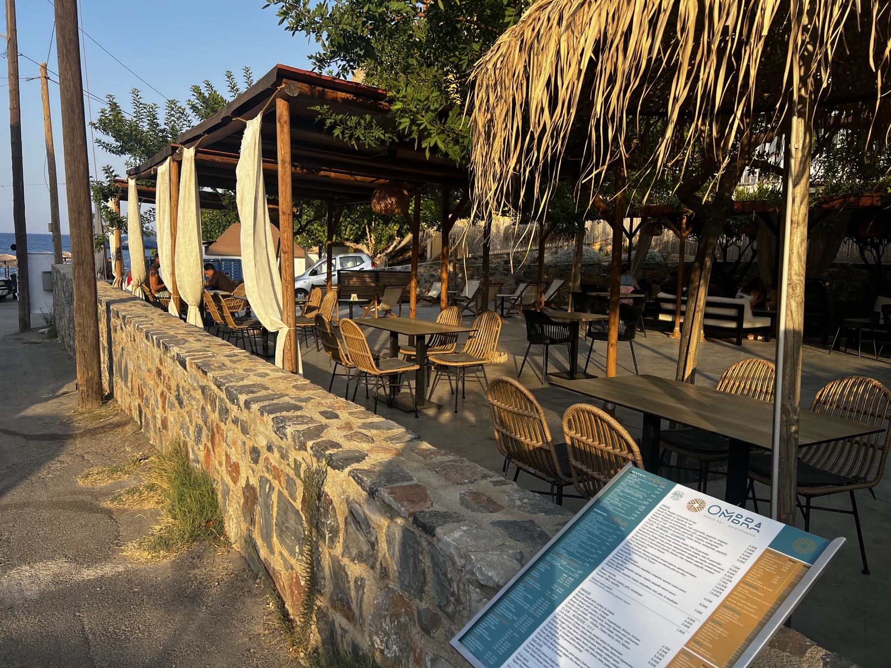 Outdoor seating at Ombra Bar near the sea
